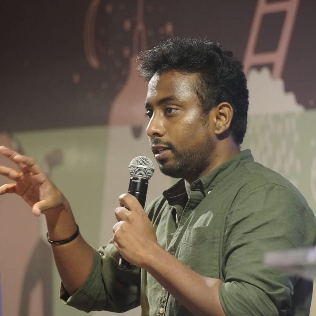 Naveen RK speaking on stage